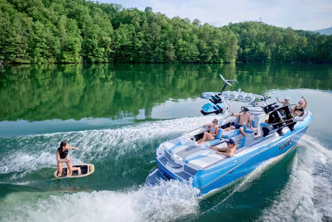 boat in water with wakeboarder