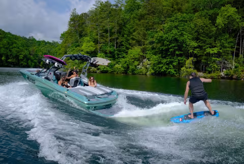 Person behind a boat surfing