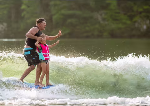 2 people wakeboarding on one board